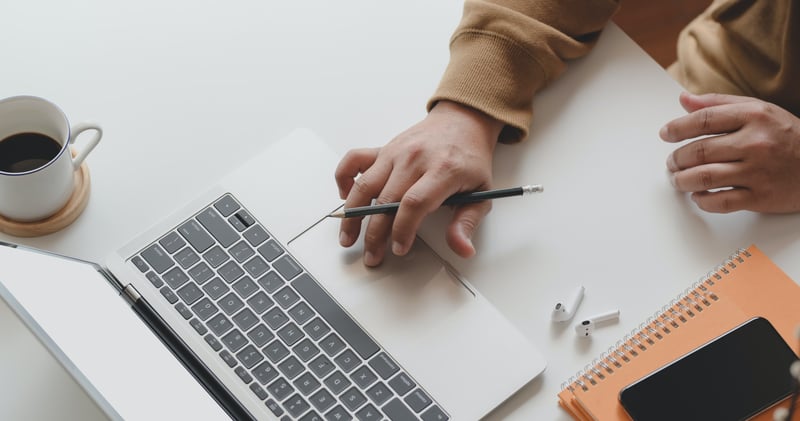 A person with no experience creating a resume on laptop