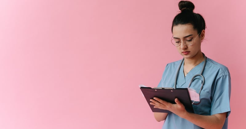 Woman in White Robe Holding Black Tablet Computer