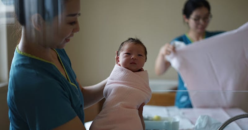 Nurse holding baby