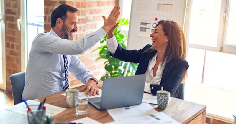 Coworkers high-fiving