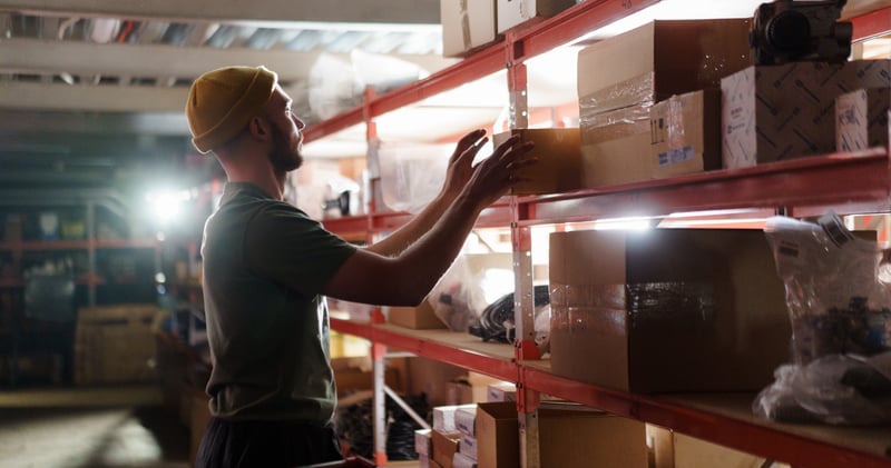 Person pulling Box from a Shelf