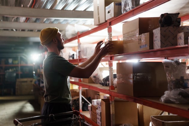 Person pulling Box from a Shelf
