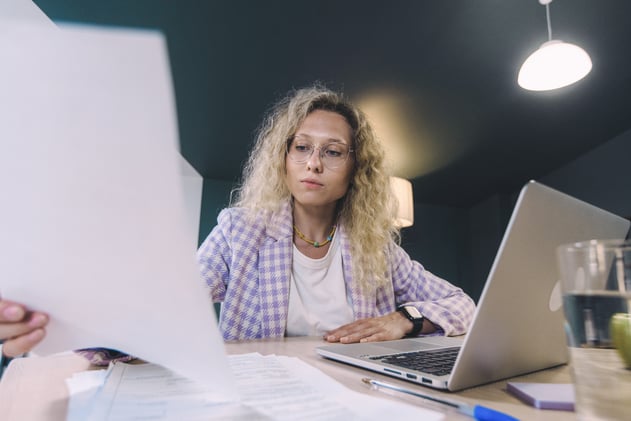 Woman with Curly Hair Holding Papers
