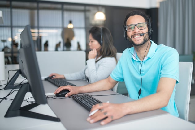 A Man and a Woman Working in a Call Center
