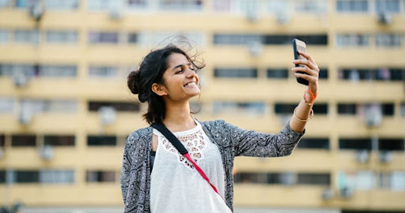 Smiling person taking selfie