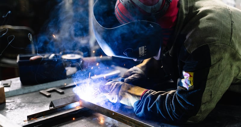 Man Welding Metal Bars
