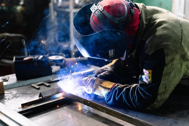 Man Welding Metal Bars

