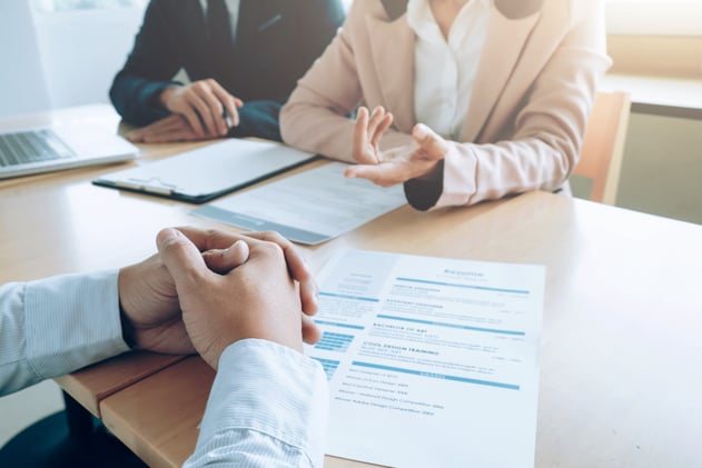 People discussing a resume at a table